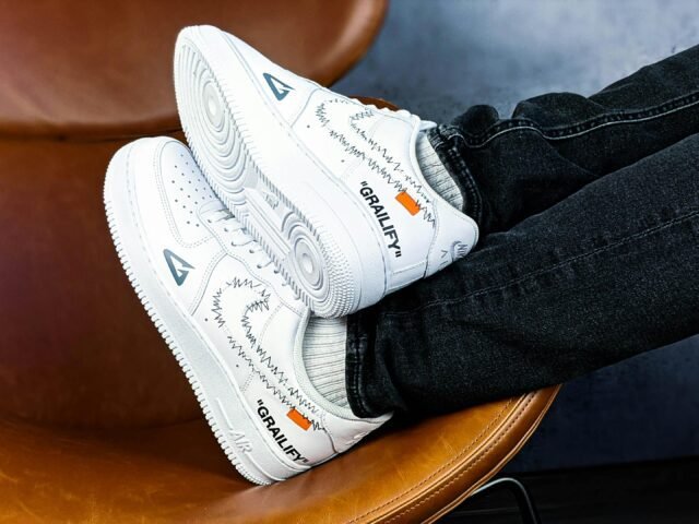 Close-up of stylish Nike sneakers with a unique design, resting on a modern chair for a trendy look.